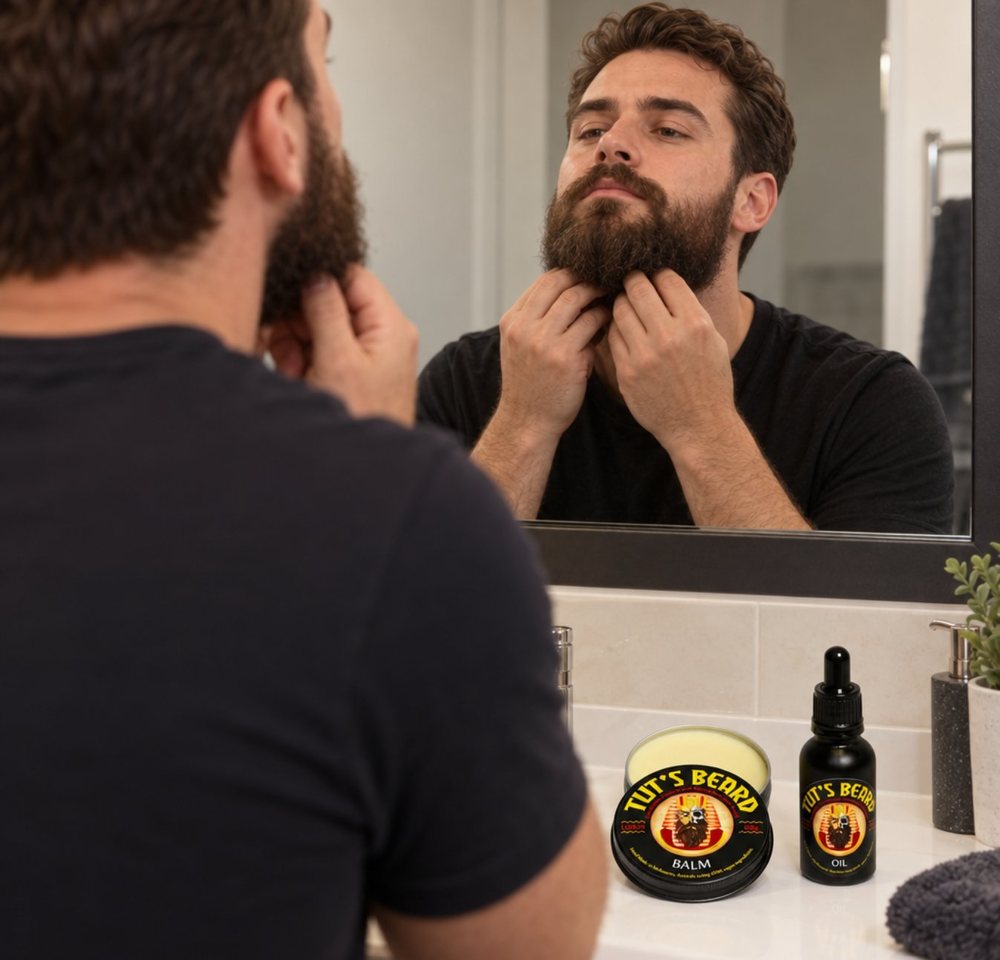 Cortex post image: a man checking his beard in a mirror, with Tut’s Beard balm and oil on the basin.