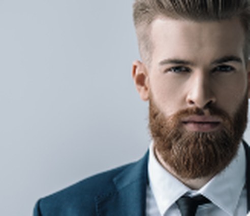 Generic AI post image: a stock photo of a model with a beard in a suit.